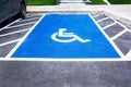 Parking lot for disabled person driver sign on road background. Parking lot sign for handicapped person Royalty Free Stock Photo