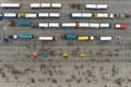 A parking lot full of passenger buses. Aerial view from above.