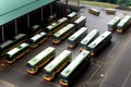 A parking lot full of passenger buses. Aerial view from above.