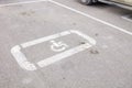 Parking lot with handicap sign and symbol. Empty reserved parking space with wheelchair symbol. Disabled person sign