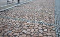 Parking lot of irregular rough red stones divided by gray granite stones. connects to the square with benches and a pedestrian zon Royalty Free Stock Photo