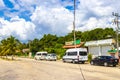 Parking lot parked tourist busses vans cars Coba Ruins Mexico