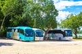 Parking lot parked tourist busses vans cars Coba Ruins Mexico