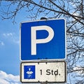 Parking lot sign with an additional note on a limited park duration of one hour