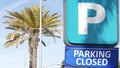 Parking lot sign as symbol of traffic difficulties and transportation issues in busy urban areas of USA. Public paid parking zone