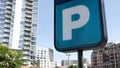 Parking lot sign as symbol of traffic difficulties and transportation issues in busy urban areas of USA. Public paid parking zone