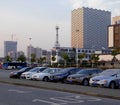 Parking lot with tall modern buildings background