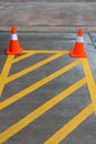 Parking lot with traffic cone on street used warning sign on road. Traffic warning cone in row to separate route in parking area. Royalty Free Stock Photo