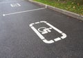 Parking lot with white painted sign of wheelchair on asphalt, parking spaces for disabled visitors Royalty Free Stock Photo