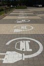 Parking lots for electric cars only. Charging stations stand in a row. Electric car sign