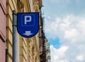 Parking meter sign, on the background of a blue sky in a close-up Royalty Free Stock Photo
