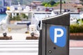 Parking meter sign blue white p car parked in city street of harbor town Royalty Free Stock Photo