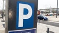 Parking meter sign letter p car parked in city street Royalty Free Stock Photo