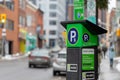 Parking meter on street with cars on road in Ottawa, Canada. Pay by phone available Royalty Free Stock Photo