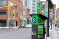 Parking meter on street with cars on road in Ottawa, Canada. Pay by phone available Royalty Free Stock Photo