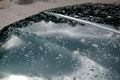 Parking near the potholes that are on the dirt road. car wash parked again is dirty from brown water with mud. green limousine has Royalty Free Stock Photo