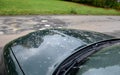 Parking near the potholes that are on the dirt road. car wash parked again is dirty from brown water with mud. green limousine has Royalty Free Stock Photo