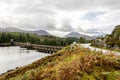 Parking near a scenic arch curved Laggan Dam structure in Scotland Royalty Free Stock Photo