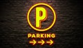 Parking neon sign. signboard on wall brick background. with arrow. parking direction symbol.