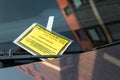 Parking penalty fine charge notice on car windscreen. Yellow notice issued by Newcastle City Council. Closeup