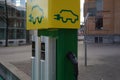 Parking place with charging stations for electric cars in green and yellow colors.