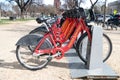 Parking for rental bikes in central Washington. A number of fixed red bicycles for rent in a mobile application