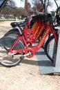 Parking for rental bikes in central Washington. A number of fixed red bicycles for rent in a mobile application