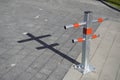 Parking Restriction Posts. Close-up of gray and red steel bollards that restrict the movement of the car`s pavement