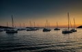 Parking of sailboats at marina in Croatia at sunset, The picturesque horizon, islands on a background, orange color