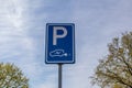 Parking sign and charging station for electric cars, blue plate with a P Royalty Free Stock Photo