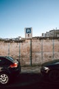 Parking Sign on Old White Wall with Blue Sky and Parked Cars in Italy Royalty Free Stock Photo