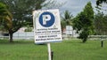 Parking sign wrote in english and bahasa `reverse parking turn off the engine` and `parkir mundur matikan mesin anda` Royalty Free Stock Photo