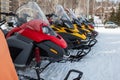 Parking of snowmobiles in a mountain village in winter Royalty Free Stock Photo