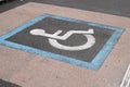 Parking space and sign for disabled in city street Royalty Free Stock Photo