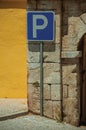 PARKING SPOT road sign in front of plaster yellow wall