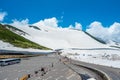 Parking spot for tourists snow mountains wall of Tateyama Kurobe alpine with blue sky background is one of the most important Royalty Free Stock Photo