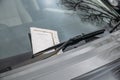 Parking ticket stuck on car windscreen for a penalty or fine. Royalty Free Stock Photo