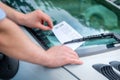 Parking ticket violation notice placed under windshield wiper Royalty Free Stock Photo