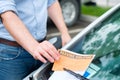 Parking ticket violation notice placed under windshield wiper Royalty Free Stock Photo