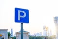 Parking traffic road sign on the right side and background of blue sky. Paid parking sign. Blurred background Royalty Free Stock Photo