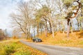 Parking under autumnal trees by the roadside