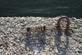 Parking the yacht to pier with mooring spring on rusty metal ring Royalty Free Stock Photo