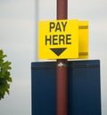 Parking your car: pay here sign.