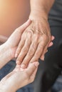 Parkinson disease patient, Alzheimer elderly senior, Arthritis person`s hand in support of nursing family caregiver care Royalty Free Stock Photo