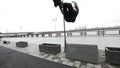 Parkour - a tracer blonde man jumps a flip outdoor