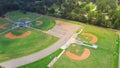 Parkside residential neighborhood near large sport complex with multiple baseball, softball fields surrounding by lush green trees