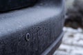 Parktronic sensor of the car covered with frost on the rear bumper in winter