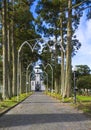 Parkway with small white and gray church of Sao Nicolau at the village of Sete Cidades on the island of Sao Miguel Royalty Free Stock Photo