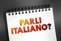 Parli Italiano? (do you speak Italian?) text quote on notepad, concept background Royalty Free Stock Photo