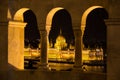 Parliament Building in Budapest framed by pillars at night Royalty Free Stock Photo